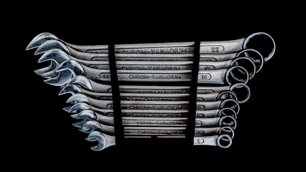 Set of chrome-vanadium wrenches neatly organized on a black background.